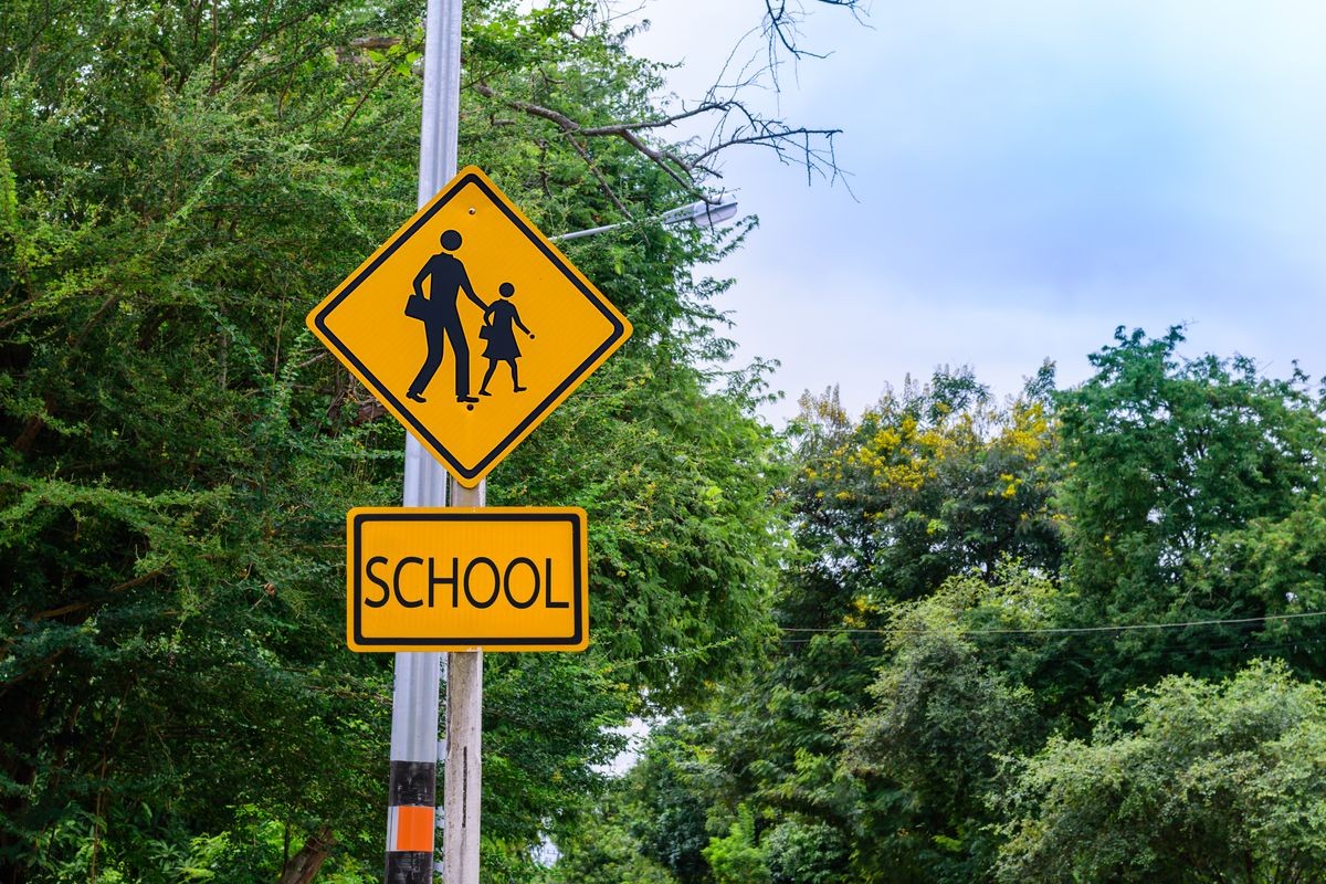 Warning sign, school sign for students school crossing the street.