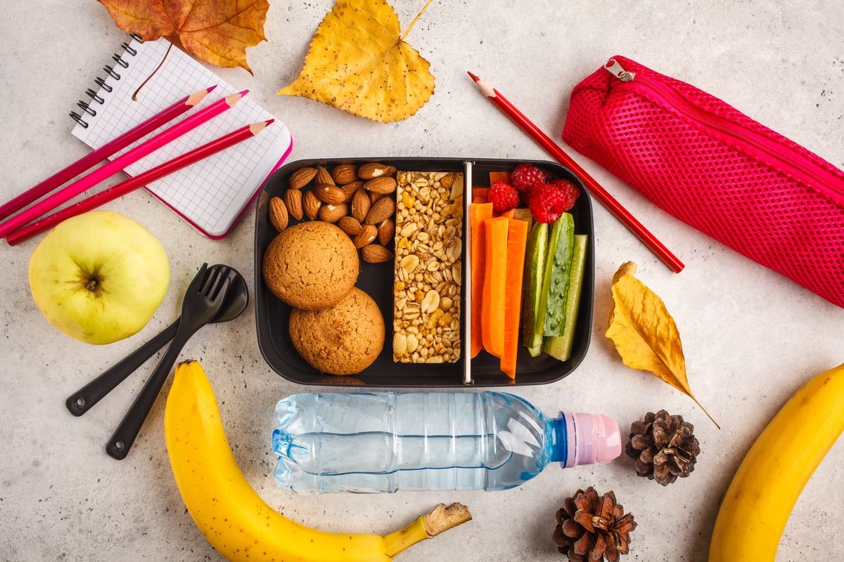 Healthy meal prep containers with fruits, berries, snacks and vegetables. Takeaway food on white background, top view. Lunch box to school.